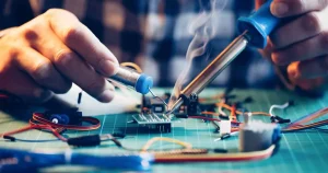 Electronics Technician soldering components on a PCB